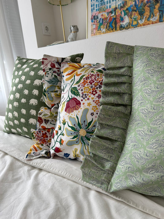 Cushion cover in green patterned fabric